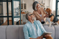A photo of a father and daughter discussing her house sale on the family sofa