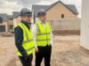 A photo of Chris Maughan and Simon Gallacher assessing progressing on a new build development from Stronghold Homes